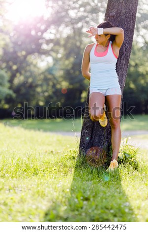 Young woman being exhausted after exercising in nature