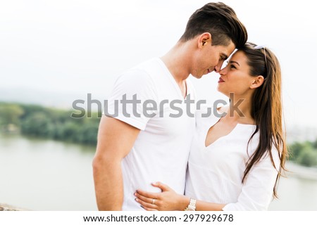 Young beautiful couple rubbing noses as a sign of love and about to kiss each other