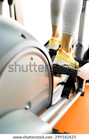 Closeup of a woman using a stepper and training in a fitness center