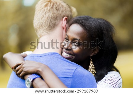 Couple in love hugging peacefully outdoors and being truly happy. Feeling of security and serenity