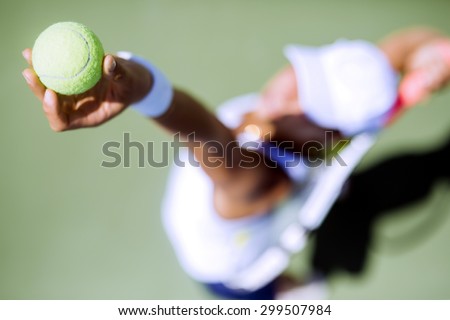 Beautiful female tennis player serving outdoor and a closeup of the serve from above