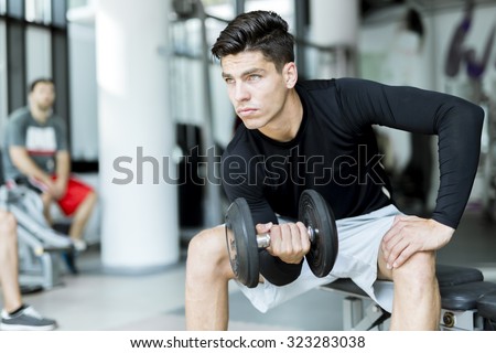 Young handsome man training in a fitness center