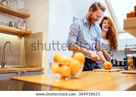 Couple making fresh organic juice in kitchen together