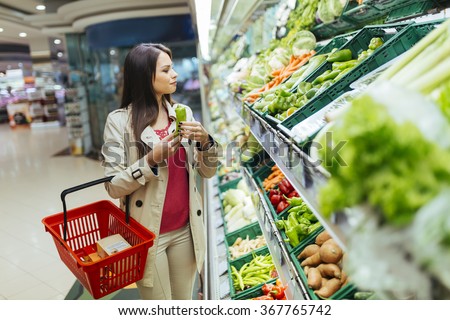 Beautiful women shopping vegetables and fruits in supermarket