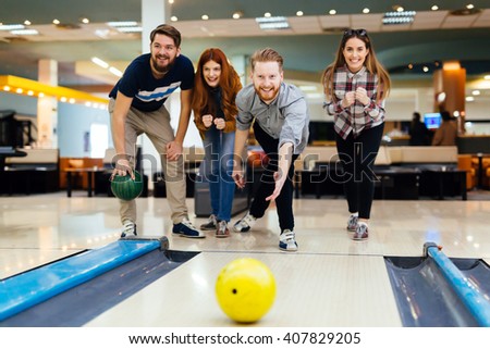 Friends enjoying recreational  bowling at club