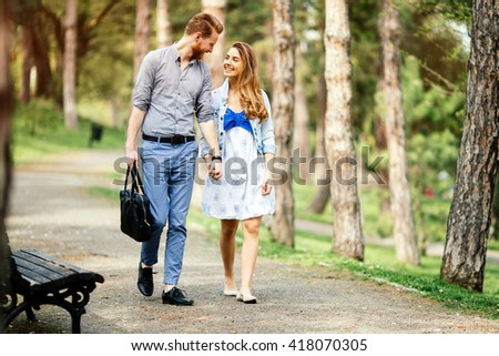 Beautiful couple taking a walk in  city park