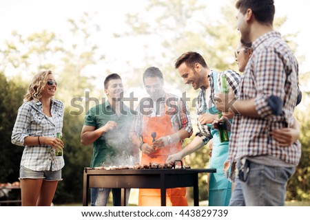 Friends camping and having a barbecue in nature
