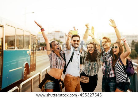 Cheerful friends travelling, taking selfies and smiling