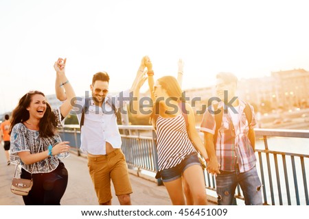 Young energetic group of people having fun in city