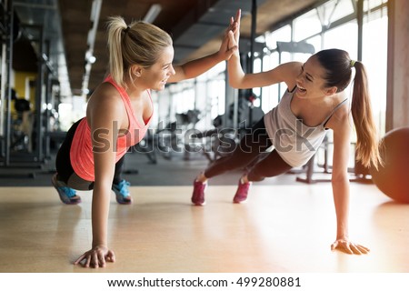 Beautiful women working out in gym together