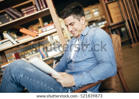 Handsome man studying by reading books and preparing for exam