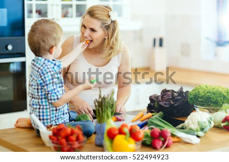 Mother and child preparing lunch from fresh veggies