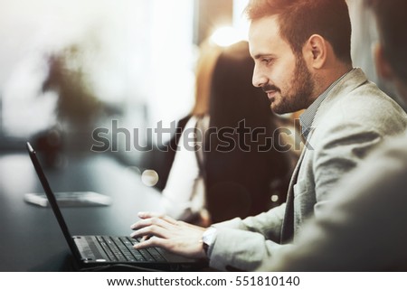 Programmer working and developing software  in office on laptop