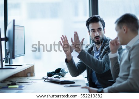 Business IT colleague explaining project details in office