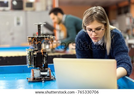 Young woman engineer working on robotics project