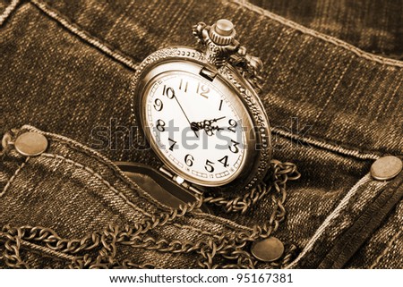 Closeup pocket watch in pocket of jeans