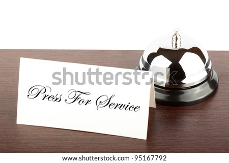 Service Bell with Press For Service Sign at Hotel Desk