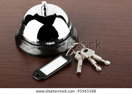 Service bell with keys on the wood background