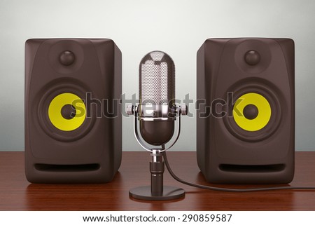 Old Style Photo.  Vintage silver microphone and Audio Speakers on the table