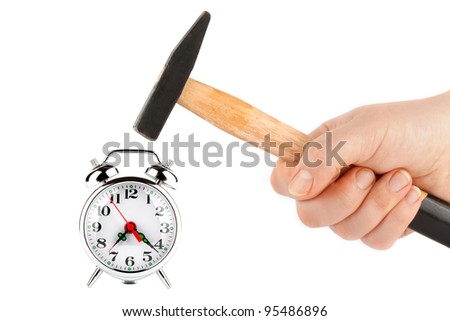 Time management - Hand holding a hammer about to hit the alarm clock