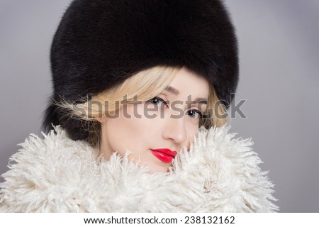 Winter Woman in Luxury Fur Coat. Beauty Fashion Model Girl. Beautiful winter girl in winter knitted hat and scarf