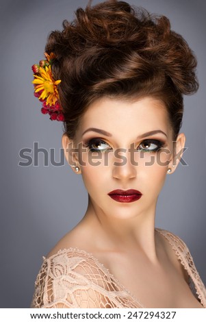 Fashion Beauty Model Girl with Flowers Hair. Bride. Perfect Creative Make up and Hair Style. Hairstyle. Bouquet of Beautiful Flower
