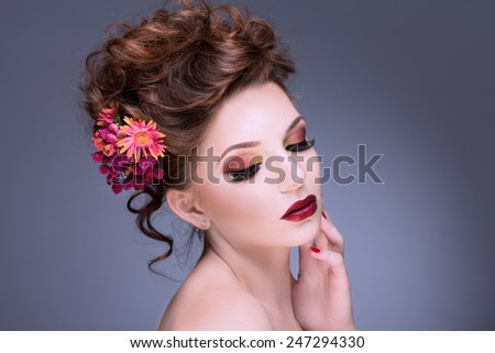 Fashion Beauty Model Girl with Flowers Hair. Bride. Perfect Creative Make up and Hair Style. Hairstyle. Bouquet of Beautiful Flower