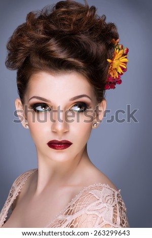 Fashion Beauty Model Girl with Flowers Hair. Bride. Perfect Creative Make up and Hair Style. Hairstyle. Bouquet of Beautiful Flower in hair