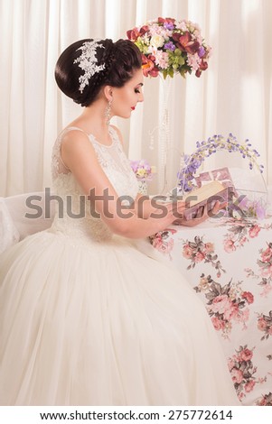 Beautiful and fashion bride in luxury interior. Portrait of Beautiful Bride with Long Hair and Fashion MakeUp. Close Up