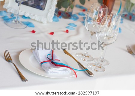 Table set for a wedding dinner with flowers. Table set for an event party or wedding reception