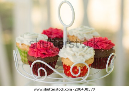 Small cakes with different stuffing. Many tiny cakes with strawberry, whipped cream, jelly and mint