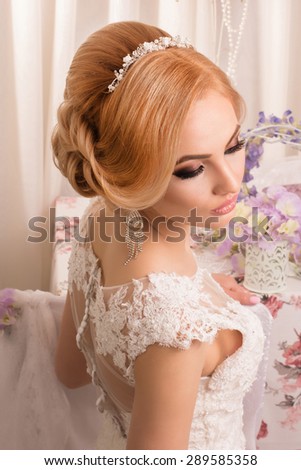 Portrait of Beautiful Bride. Beautiful bride in a wedding-dress is in fashion style. Wedding decorations