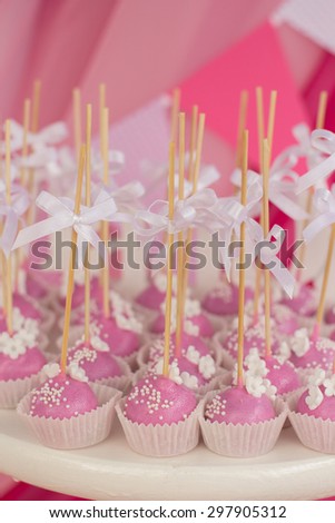 Small cakes with different stuffing. Many tiny cakes with strawberry, whipped cream