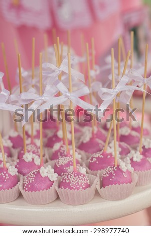 Small cakes with different stuffing. Many tiny cakes with strawberry, whipped cream