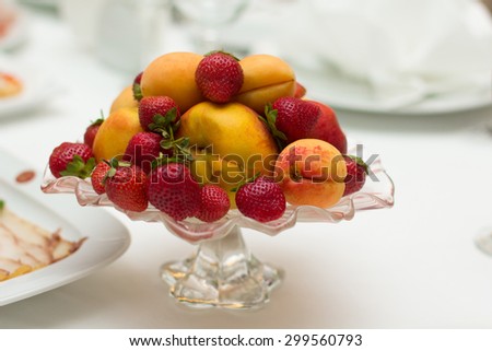 Mixed fruit platter. Variety of fruit on a plate includes, strawberry, apricot, peach, pear, mango, pineapple, juicy, fresh, healthy