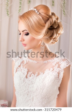 Beauty woman with wedding hairstyle and makeup. Bride fashion. Jewelry and Beauty. Woman in white dress,perfect skin. Girl with stylish haircut. Skincare.