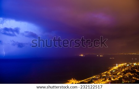 Fantastic night storm with lightning over the city on Mediterranean bay