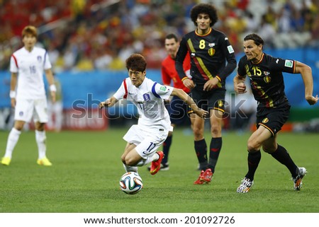 SAO PAULO, BRAZIL - June 26, 2014: Daniel Van Buyten of Belgium and Lee Chungyong of Korea compete for the ball during the game between Belgium and Korea at Arena Corinthians. No Use in Brazil.