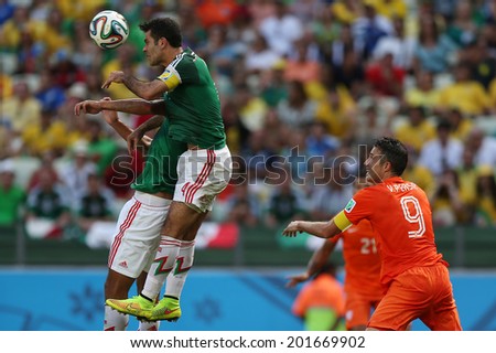 FORTALEZA, BRAZIL - JUNE 29, 2014: Marquez of Mexico and Van Persie of Netherlands during the World Cup Round of 16 game between the Netherlands and Mexico in the Castelao stadium. NO USE IN BRAZIL.