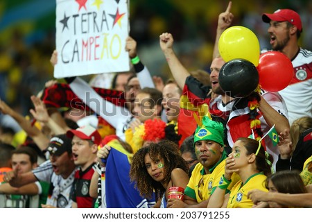BELO HORIZONTE, BRAZIL - July 8, 2014: Brazil soccer fans in shock, German fans celebrate during the 2014 World Cup Semi-finals game between Brazil and Germany at Mineirao Stadium. NO USE IN BRAZIL.