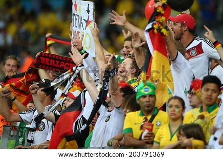 BELO HORIZONTE, BRAZIL - July 8, 2014: German soccer fans celebrate, Brazil fans in shock during the 2014 World Cup Semi-finals game between Brazil and Germany at Mineirao Stadium. NO USE IN BRAZIL.