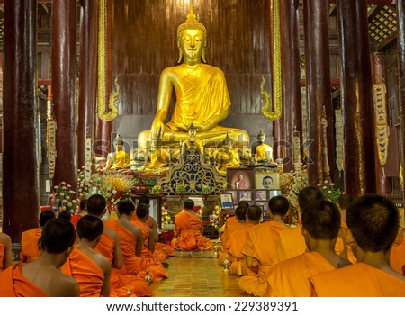 CHIANG MAI, THAILAND - NOVEMBER 04, 2014: Buddhist monks meditating in front of the Buddha image in Phan Tao Temple.