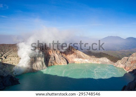 Colorful Ijen volcano crater lake and Raung volcano at the background