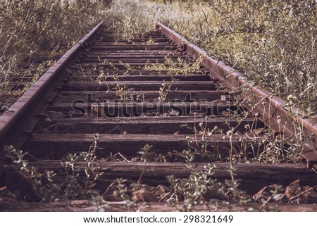 disused railway track on the field,warm light tone