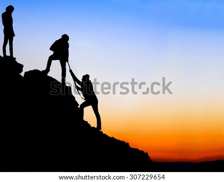 Silhouette of helping hand between three climber