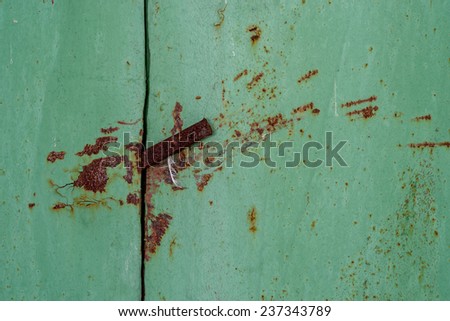 Detail of a metal rod inserted to open a stuck metal door