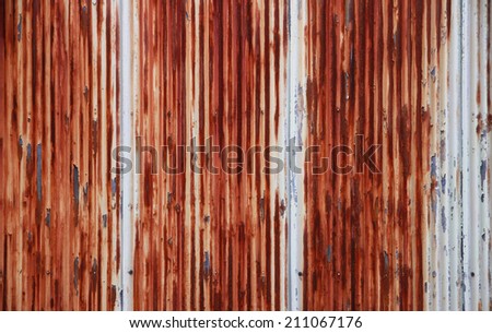 Texture of a rusty corrugated metal fence