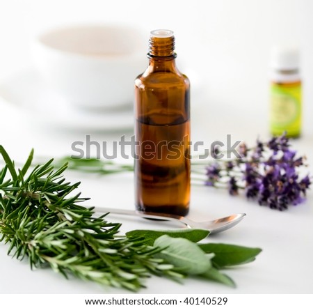 Herbal medicine with herbs and a cup of tea on table. Isolated white background. Studio shot.