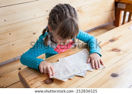 Little girl looking at the treasure map.
