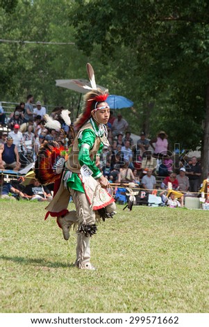 KAHNAWAKE, QUEBEC, CANADA - JULY 12, 2015 : Pow pow dancers take part in Kahnawake 25th Annual Echoes Of A Proud Nation Pow Wow in Kahnawake reserve, Quebec, Canada on July 12, 2015